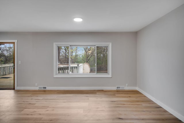 spare room with baseboards, recessed lighting, light wood-style flooring, and visible vents
