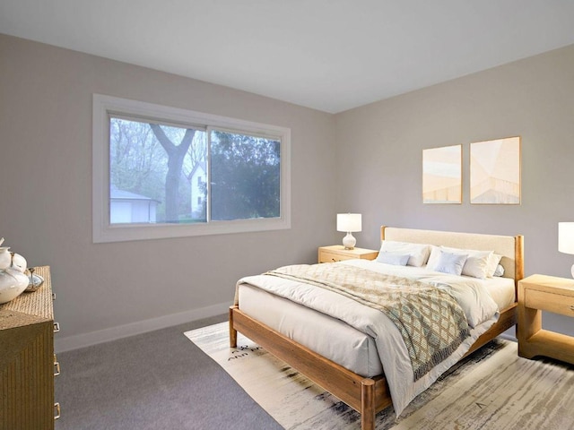 bedroom with carpet floors and baseboards