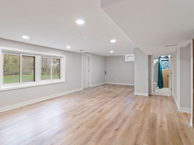 below grade area with recessed lighting, light wood finished floors, and baseboards