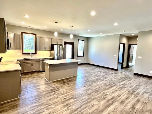 kitchen featuring recessed lighting, appliances with stainless steel finishes, a sink, and wood finished floors