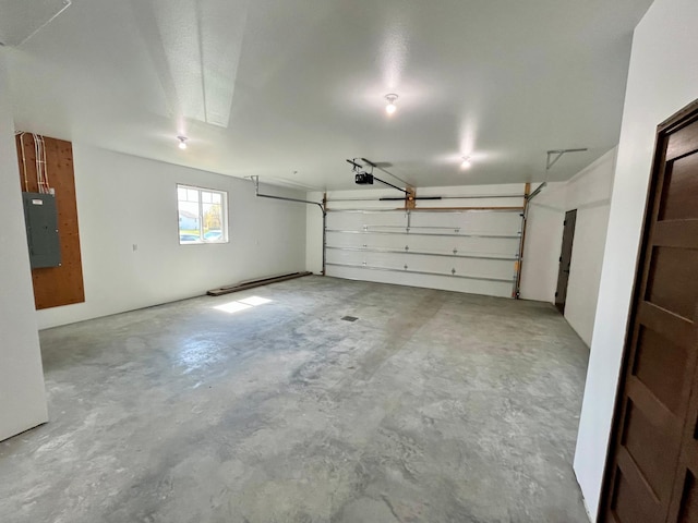 garage featuring electric panel and a garage door opener