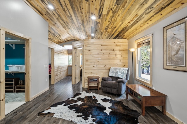 living area featuring dark wood finished floors, wood ceiling, baseboards, and lofted ceiling