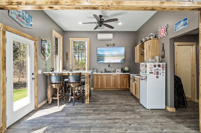 kitchen with a wall mounted air conditioner, freestanding refrigerator, recessed lighting, dark wood-style floors, and a ceiling fan