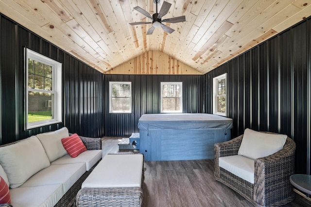 living area with lofted ceiling, a healthy amount of sunlight, ceiling fan, and wooden ceiling