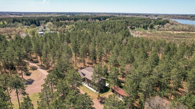 birds eye view of property featuring a wooded view and a water view