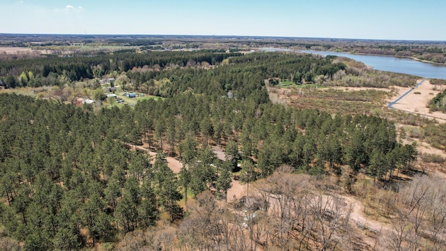 aerial view with a wooded view and a water view