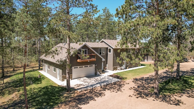 6070 Aspen Rd, Princeton, MN 55371 - chalet / cabin featuring a balcony, driveway, a front lawn, and a garage