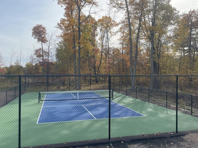 view of sport court featuring fence