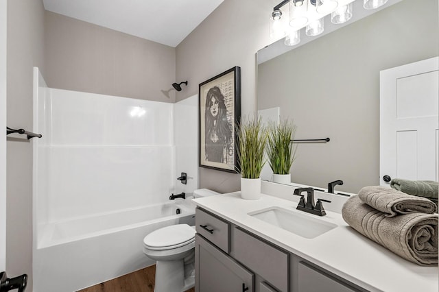 full bathroom featuring vanity, toilet, wood finished floors, and shower / tub combination
