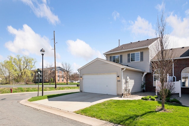 view of front facade featuring an attached garage, driveway, and a front yard