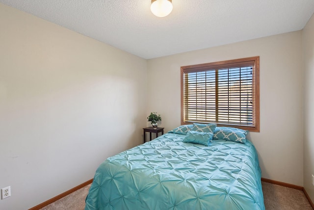 carpeted bedroom featuring baseboards