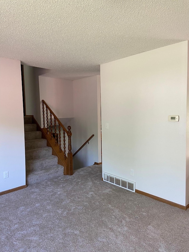 204 8th St N, Sartell, MN 56377 - unfurnished living room featuring carpet, a textured ceiling, and baseboards