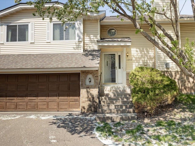 1042 Aston Cir, Burnsville, MN 55337 - view of front of home featuring a garage and a shingled roof