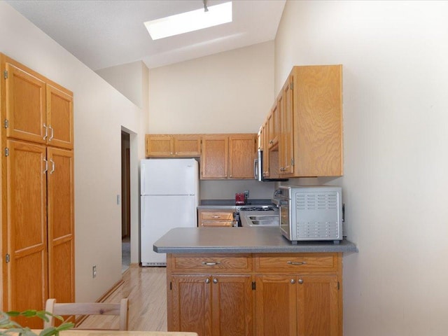 1042 Aston Cir, Burnsville, MN 55337 - kitchen with freestanding refrigerator, stove, a peninsula, light wood finished floors, and stainless steel microwave