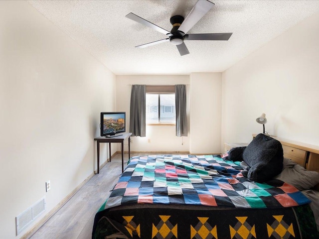 1042 Aston Cir, Burnsville, MN 55337 - bedroom with a textured ceiling, light wood-style flooring, ceiling fan, and baseboards
