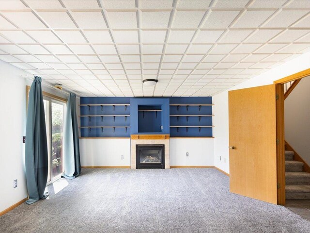1042 Aston Cir, Burnsville, MN 55337 - unfurnished living room featuring carpet flooring, stairway, a fireplace, and baseboards