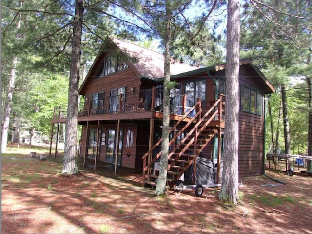 back of house featuring a wooden deck