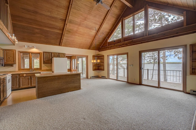 10121 Comstock Rd, Hayward, WI 54843 - kitchen featuring white appliances, wooden ceiling with exposed beams, high vaulted ceiling, a center island, and light colored carpet