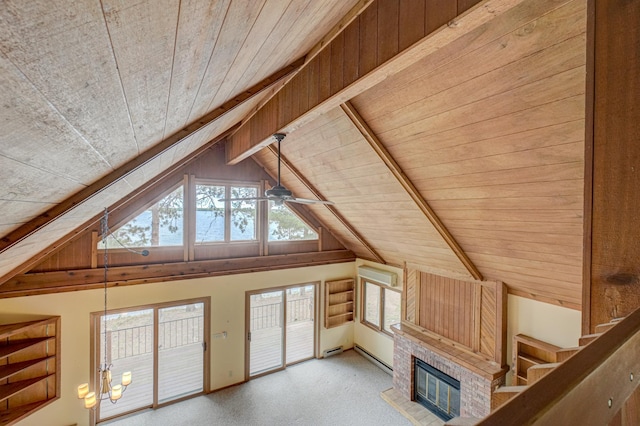 10121 Comstock Rd, Hayward, WI 54843 - unfurnished living room with wood ceiling, vaulted ceiling, plenty of natural light, a brick fireplace, and a ceiling fan