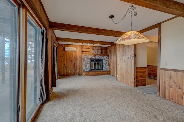 10121 Comstock Rd, Hayward, WI 54843 - unfurnished living room featuring wooden walls, an AC wall unit, beam ceiling, carpet, and a fireplace
