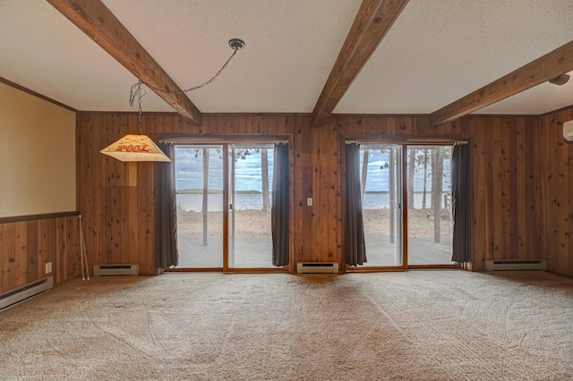 10121 Comstock Rd, Hayward, WI 54843 - unfurnished living room featuring wood walls, baseboard heating, beam ceiling, carpet flooring, and a baseboard radiator