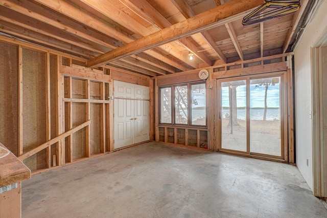 10121 Comstock Rd, Hayward, WI 54843 - miscellaneous room with plenty of natural light, unfinished concrete flooring, and a water view