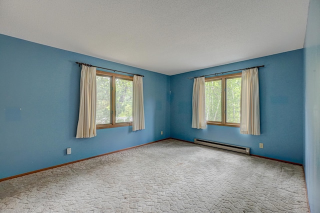 10121 Comstock Rd, Hayward, WI 54843 - empty room with a baseboard heating unit, carpet floors, baseboards, and a textured ceiling