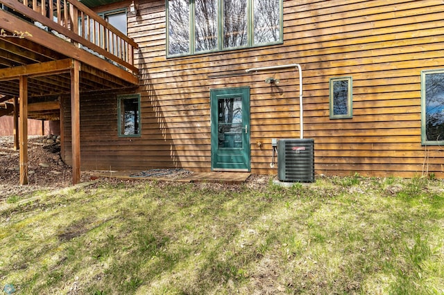 23898 324th Ave, Sverdrup Twp, MN 56586 - doorway to property with central air condition unit, a yard, and a deck