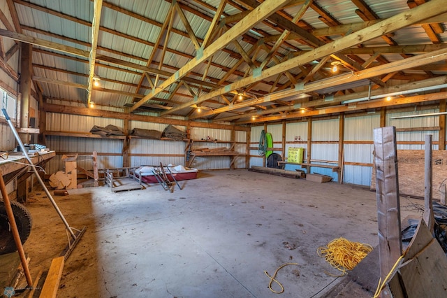 23898 324th Ave, Sverdrup Twp, MN 56586 - misc room with lofted ceiling, metal wall, a garage, and unfinished concrete flooring