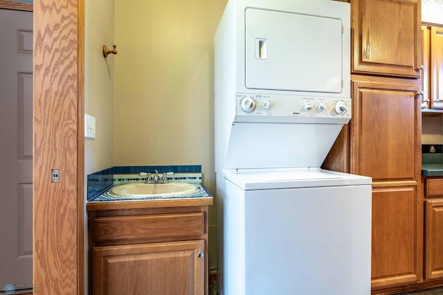 23898 324th Ave, Sverdrup Twp, MN 56586 - laundry area featuring stacked washer and dryer, a sink, and cabinet space