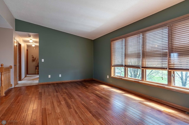 23898 324th Ave, Sverdrup Twp, MN 56586 - empty room featuring baseboards, lofted ceiling, and hardwood / wood-style flooring