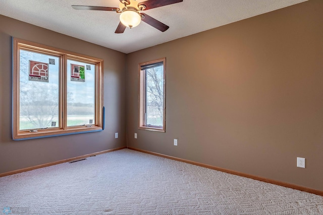 23898 324th Ave, Sverdrup Twp, MN 56586 - carpeted spare room with a textured ceiling, visible vents, baseboards, and ceiling fan