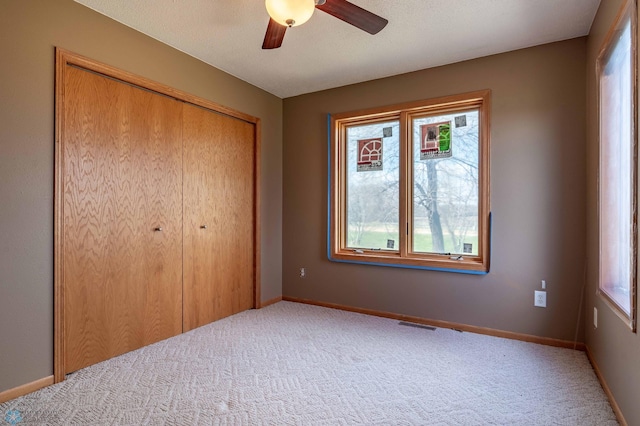 23898 324th Ave, Sverdrup Twp, MN 56586 - unfurnished bedroom featuring carpet flooring, a closet, baseboards, and a ceiling fan
