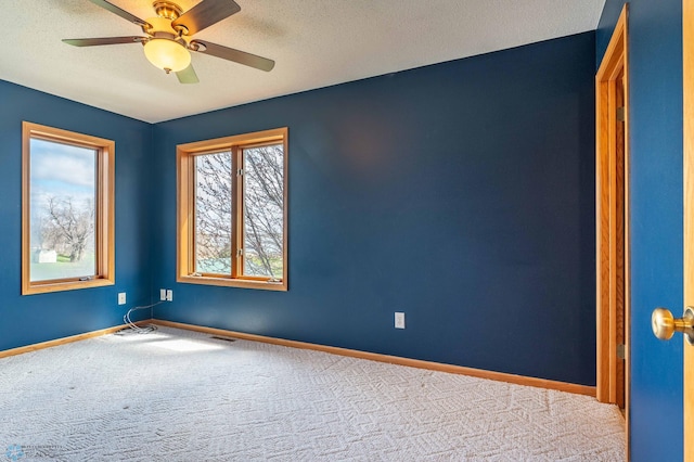 23898 324th Ave, Sverdrup Twp, MN 56586 - empty room featuring a textured ceiling, carpet, visible vents, a ceiling fan, and baseboards