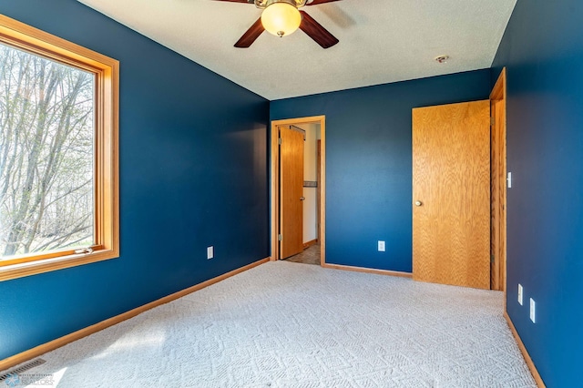 23898 324th Ave, Sverdrup Twp, MN 56586 - unfurnished bedroom with carpet floors, baseboards, visible vents, and multiple windows