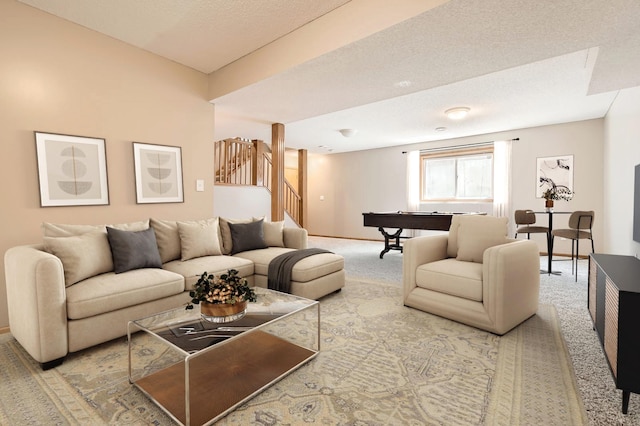 living area with carpet flooring, billiards table, stairway, and a textured ceiling