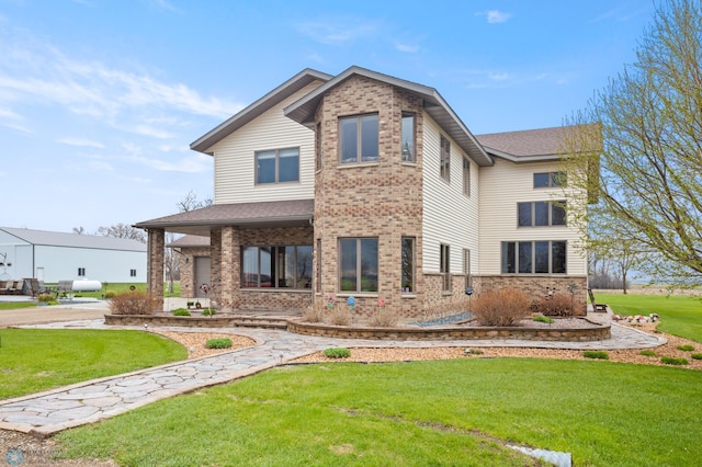 6435 172nd Ave SE, Colfax, ND 58018 - rear view of property featuring brick siding and a lawn