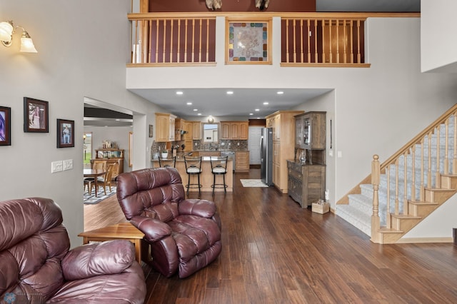 6435 172nd Ave SE, Colfax, ND 58018 - living room with stairs, a towering ceiling, and dark wood-style floors