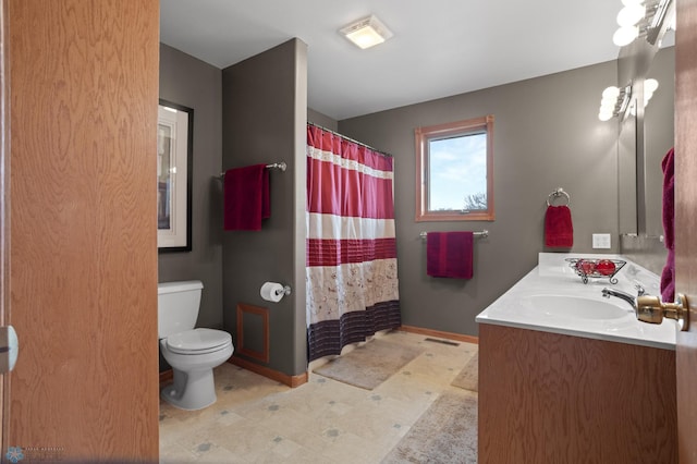6435 172nd Ave SE, Colfax, ND 58018 - bathroom with double vanity, a sink, tile patterned floors, baseboards, and toilet