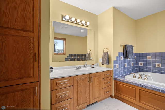 6435 172nd Ave SE, Colfax, ND 58018 - bathroom featuring vanity, marble finish floor, a bath, and visible vents