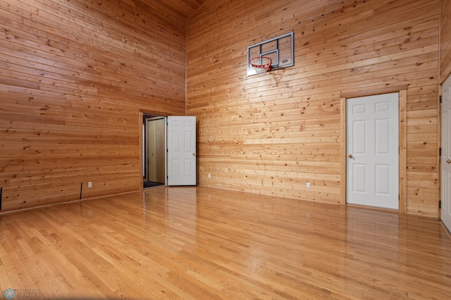 6435 172nd Ave SE, Colfax, ND 58018 - unfurnished room with light wood-type flooring, a towering ceiling, and wooden walls