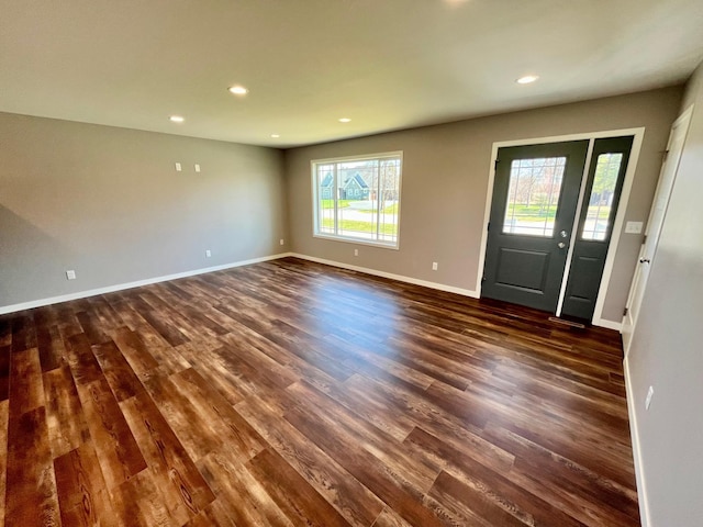 foyer entrance with baseboards, dark wood-type flooring, plenty of natural light, and recessed lighting