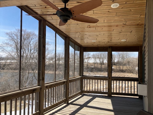 unfurnished sunroom featuring a ceiling fan