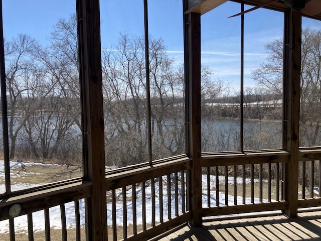 unfurnished sunroom featuring a water view
