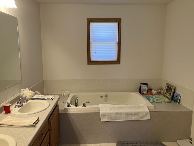 bathroom featuring double vanity, a sink, and a bath