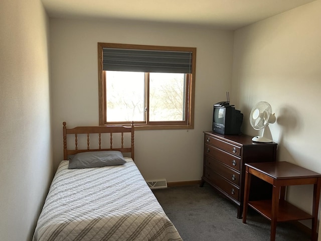 bedroom featuring baseboards, dark colored carpet, and visible vents