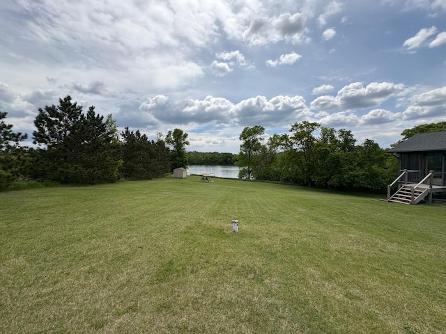 27588 226th St, Underwood, MN 56586 - view of green lawn with a water view and a sunroom