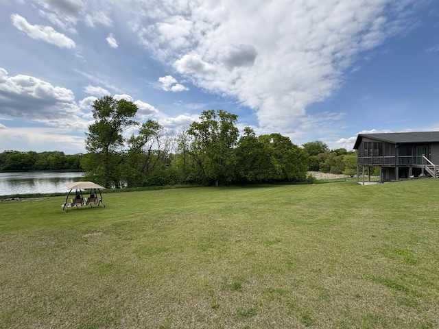 27588 226th St, Underwood, MN 56586 - view of green lawn with a water view and a sunroom
