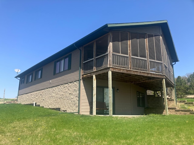 27588 226th St, Underwood, MN 56586 - back of property with a sunroom, a lawn, and a deck