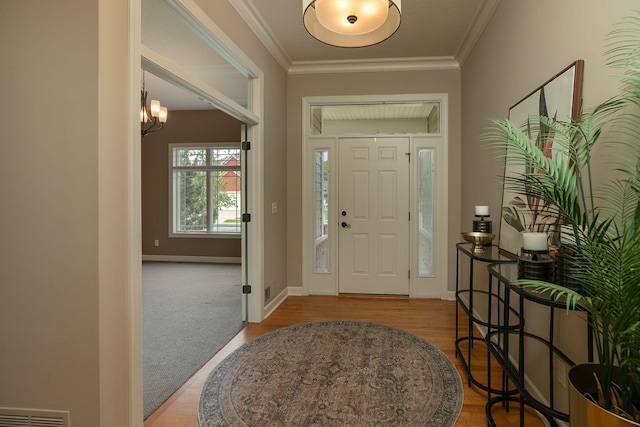 4051 Autumn Lake Ct SW, Rochester, MN 55902 - foyer featuring a chandelier, wood finished floors, and ornamental molding